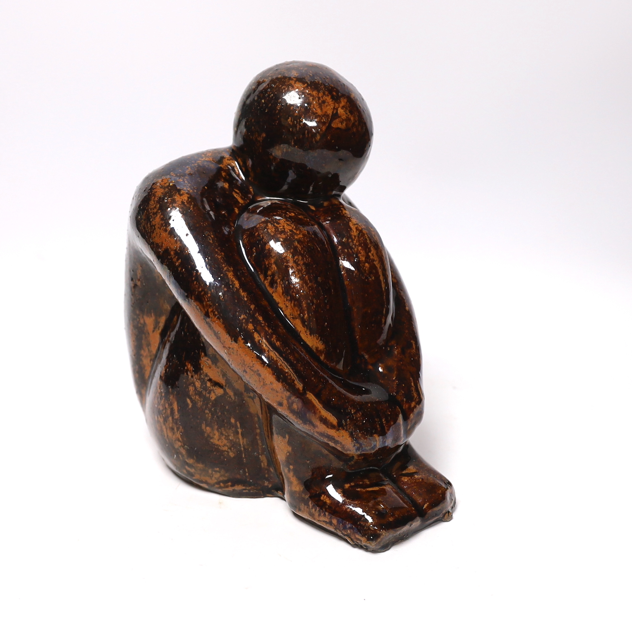 A 20th century tenmoko glazed pottery figure of a seated figure, 22cm